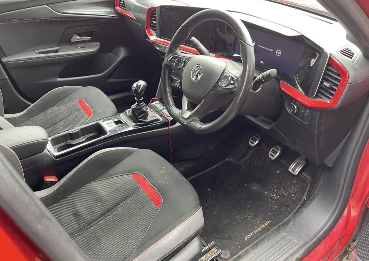 Before: Vauxhall Mokka interior with a dirty footwell full of debris